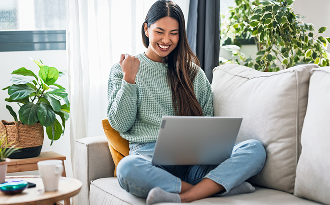 Woman sitting on a couch using a laptop
