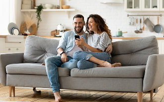 Couple sitting down looking at a laptop